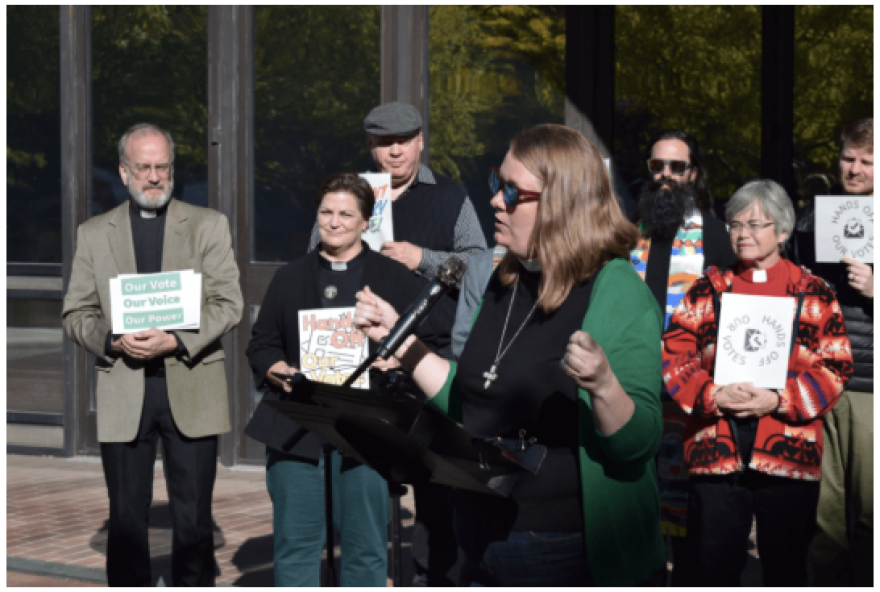Rev. Emily Kuenker speaks at a press conference in front of the Thomas S. Foley Federal Courthouse in Spokane, Wash., Oct. 6, 2026.