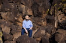 Poet Laureate Arthur Sze hikes among ancient indigenous rock carvings that inspired some of his work at La Cieneguilla Petroglyph Site near Santa Fe, New Mexico, March 12, 2026.