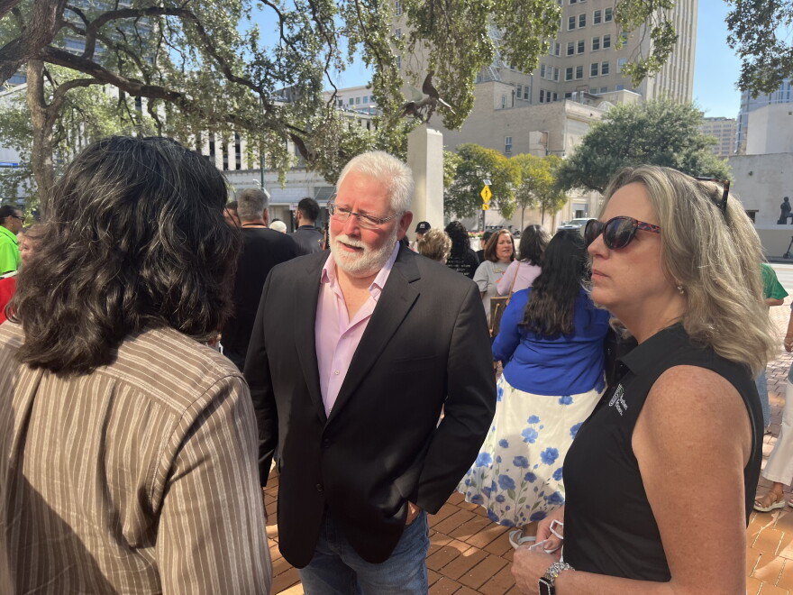Cory McRae with the Nonprofit Council speaks with District 4 Councilman Edward Mungia and Big Brothers Big Sisters of South Texas CEO Denise Barkhurst at the rally at City Hall to push back against budget cuts for nonprofits.