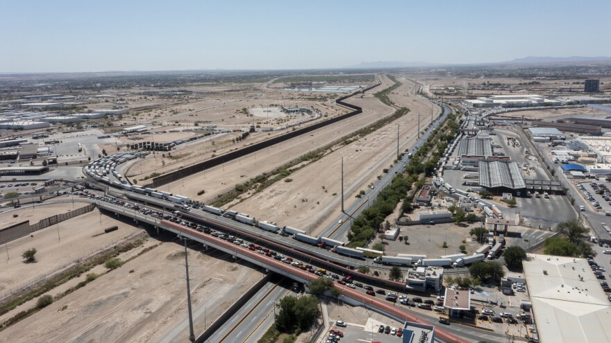 Commercial trucks in a long line on Zaragoza International Bridge connecting El Paso, Texas and Ciudad Juarez, Mexico.