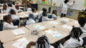 As part of a new program, Bond Hill Academy, which focuses on math and science, requires kids to wear lab coats.
