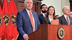 FILE - Nassau County Executive Bruce Blakeman, at podium, speaks during a news conference in Mineola, N.Y., March 6, 2024. (AP Photo/Philip Marcelo, File)