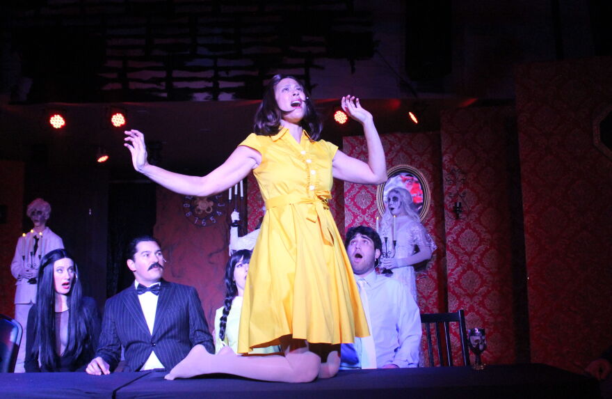 Nicole Anderson does tabletop dance during 'Full Disclosure' at the Addams mansion.