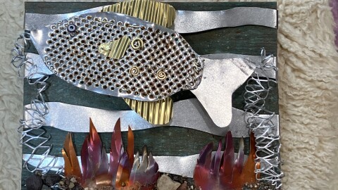 A sculpture picture featuring metal pieces to look like a scene from underwater.