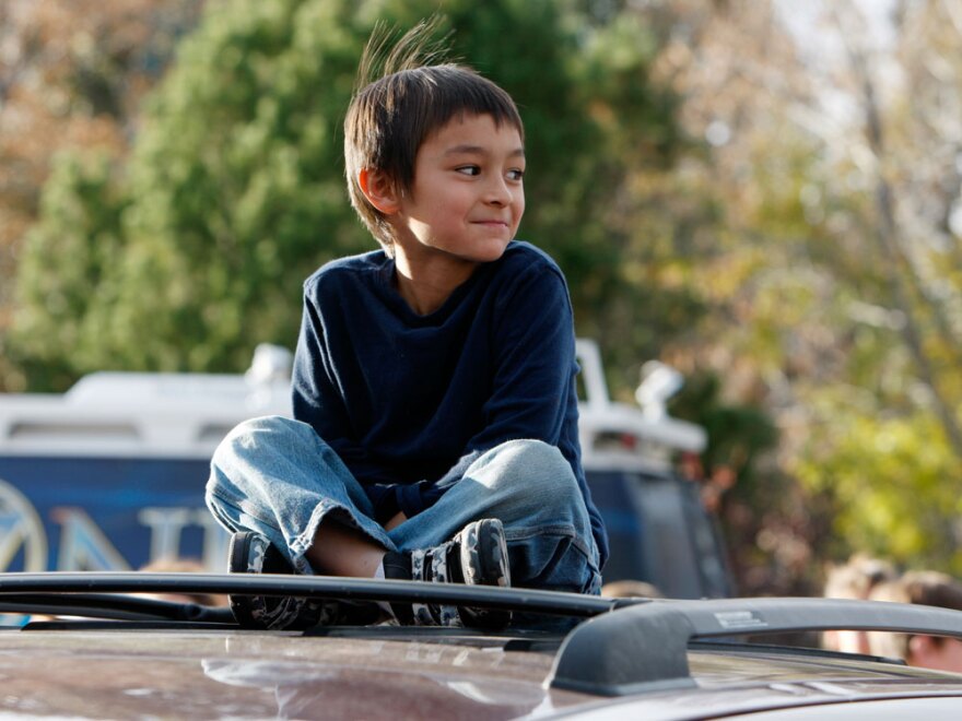 Six-year-old Falcon Heene sits on the roof of his family's van outside his home in Fort Collins, Colo. Falcon had been reported to be aboard a helium balloon over Colorado, before being discovered hiding in a box at his home.