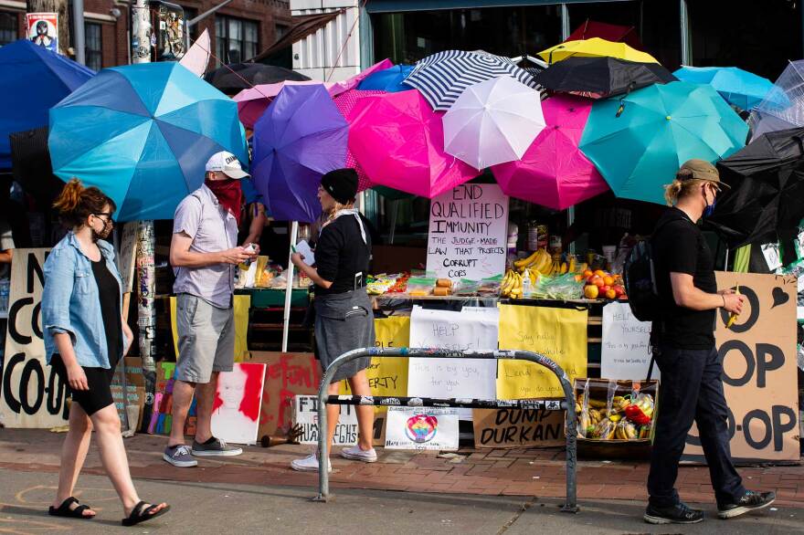 Umbrellas and umbrella imagery, which have become a symbol of the protest movement following clashes with police, are prevalent at the CHAZ.
