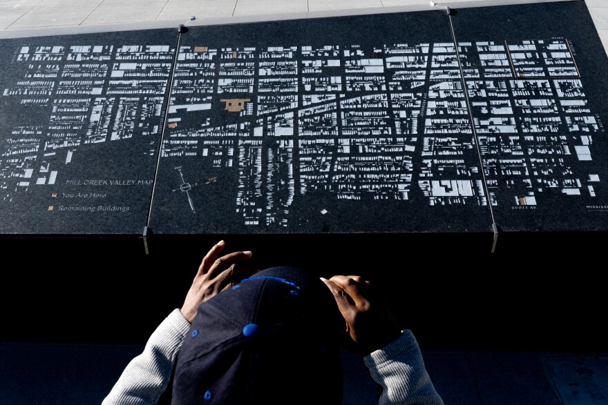 A member of the media takes a photograph of a Mill Creek Valley Map on Monday, Nov. 14, 2022, during a media walkthrough of CITYPARK, home of St. Louis City SC, in Downtown West. The neighborhood, wiped out by city officials and now where the stadium sits, is memorialized through Damond Davis’ “Pillars of the Valley” art installation.