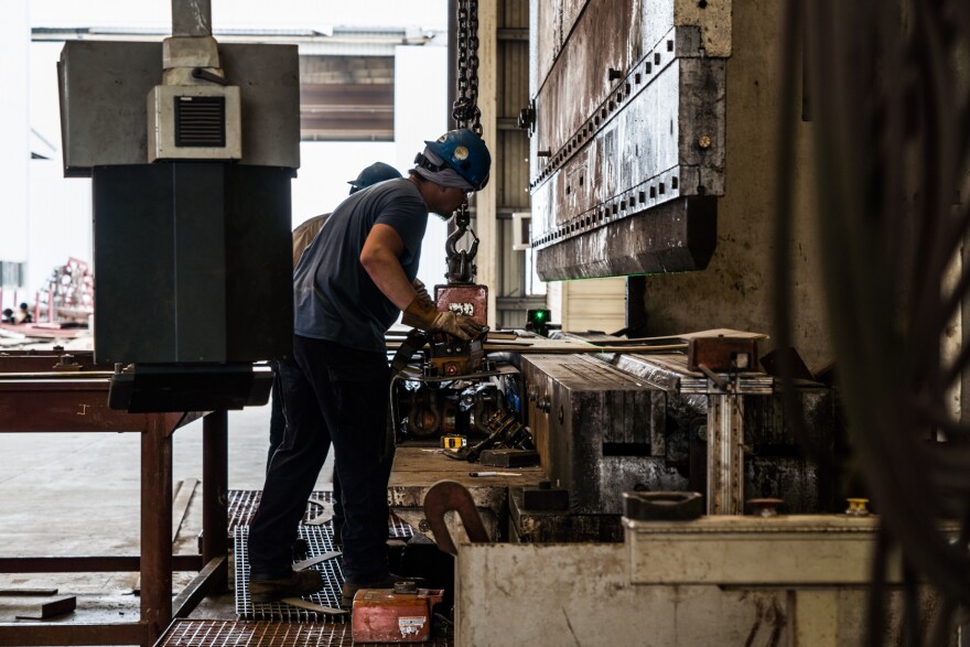 Workers press and fit sheets of metal into the correct shape for the construction of the Eco Edison at the LaShip yard in Houma, Louisiana.