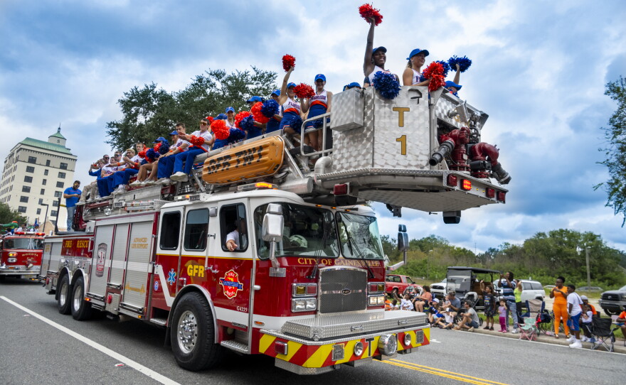UF Cheerleaders ride on a Gainesville Fire Rescue truck during the University of Florida Homecoming parade Oct. 9, 2026, in Gainesville, Fla. (Andy Acosta/WUFT News)