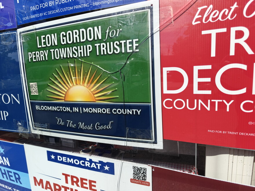 broken glass in front of campaign posters 