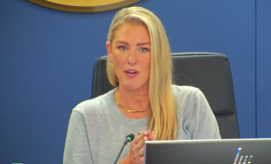 A blonde woman at a school board meeting