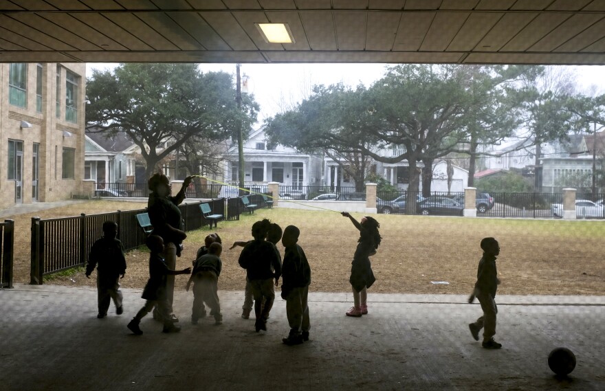 Young children play outside in the fog at Crocker College Prep, an elementary school in New Orleans.