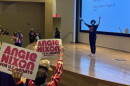 Woman on stage in front of a crowd