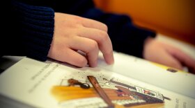 a child's hands on a book