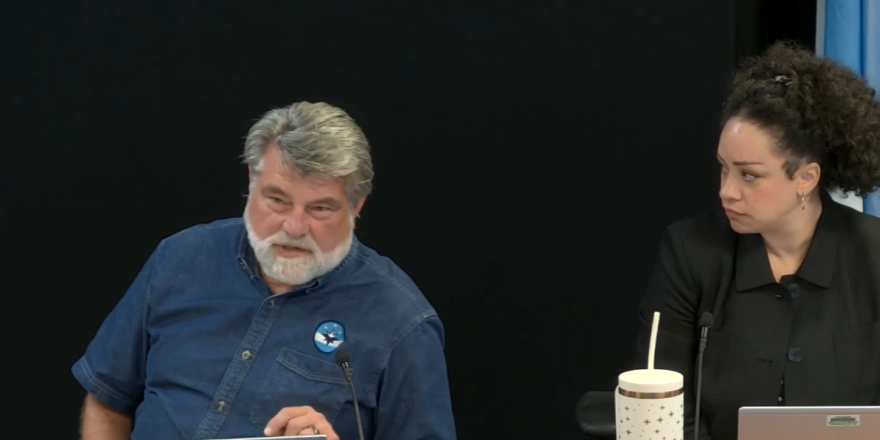 Mayor Jeff Schrag (left) says he's "not sure he heard a question" during an exchange with Craig Hosmer. Mayor Pro Tem Heather Hardinger (right) looks on.