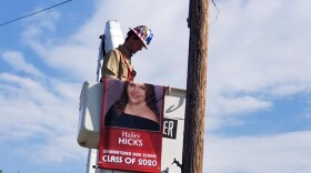 Gulf Coast Electric hanging up banner for Wewahitchka High School Class of 2020 graduate.