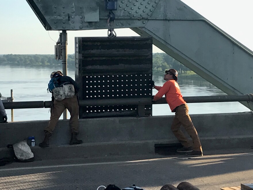 Workers position outer and inner anchor weldments in place last month on the I-40 bridge over the Mississippi River as part of the ongoing repair.