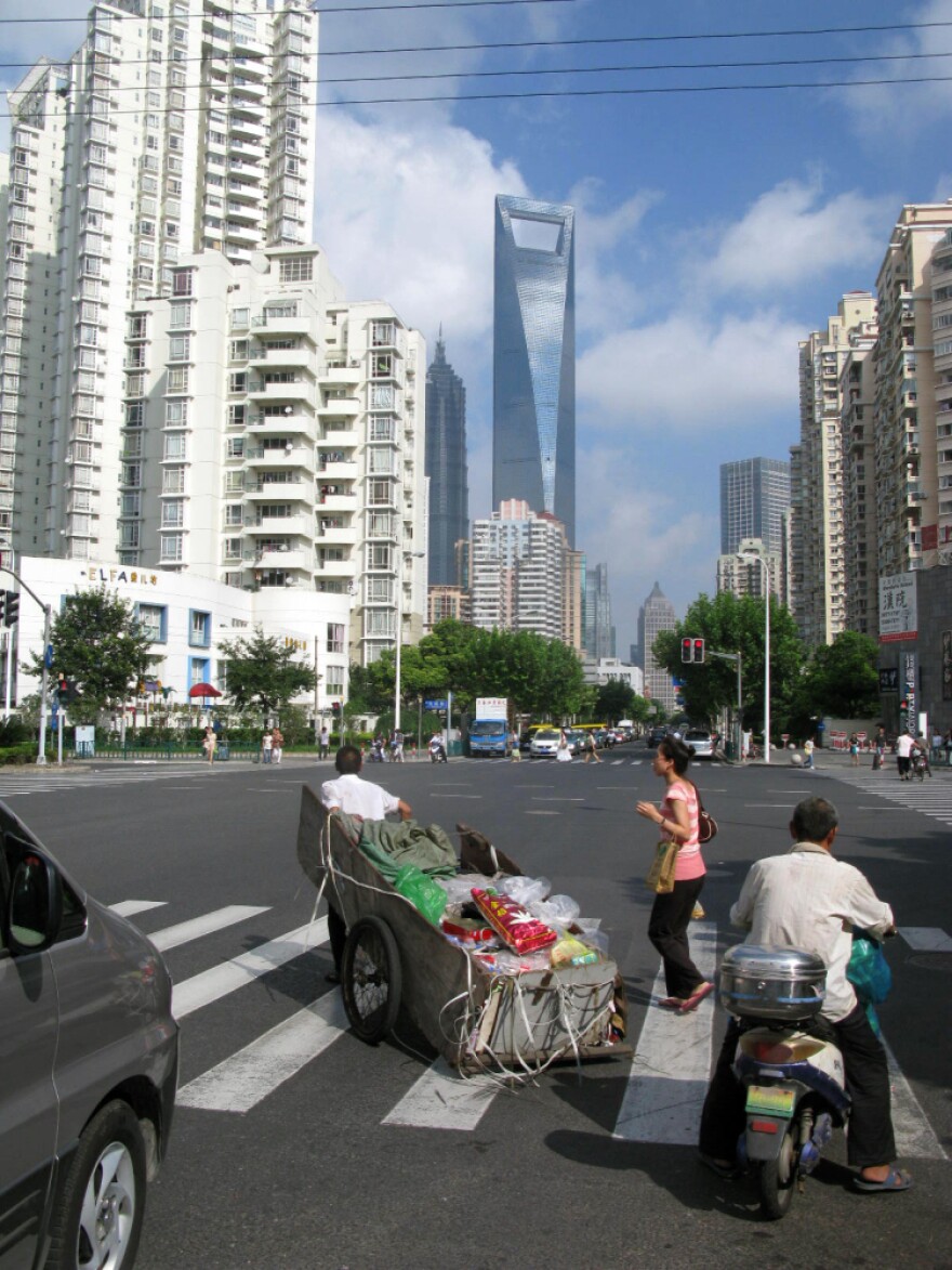<p>Despite its ultra-modern skyscrapers and paved streets, some Shanghai residents still transport items on carts.</p>