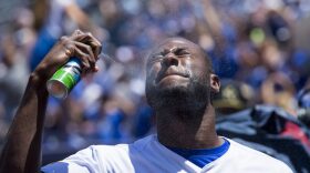 The ingredients in chemical sunscreen enter the bloodstream after just one day of use, according to a new study conducted by the Food and Drug Administration. Pictured: Lorenzo Cain of the Kansas City Royals sprays sunblock on his face before a Major League Baseball game in 2017. (Kyle Rivas/Getty Images)