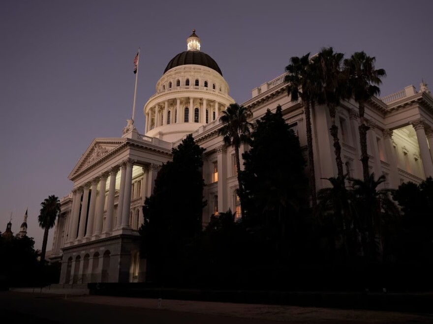 The lights of the state Capitol glow into the night in Sacramento, Calif., Wednesday, Aug. 31, 2022.
