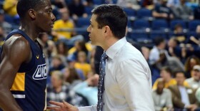 UNCG guard Isaiah Miller chats with head coach Wes Miller during a game in 2019 at the Greensboro Coliseum.