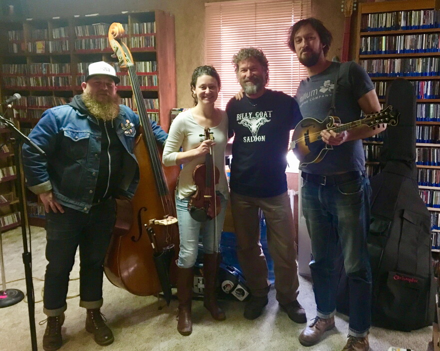 Jim Belcher, flanked by member of the Stillhouse Junkies, following an in-studio performance at KSUT.