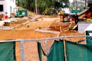 Construction site and equipment behind a gate.