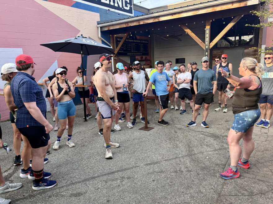 Mari Barlow (2nd from right) shares community running updates at the start of a Runaways event at Oxbow Brewing Co. in July.