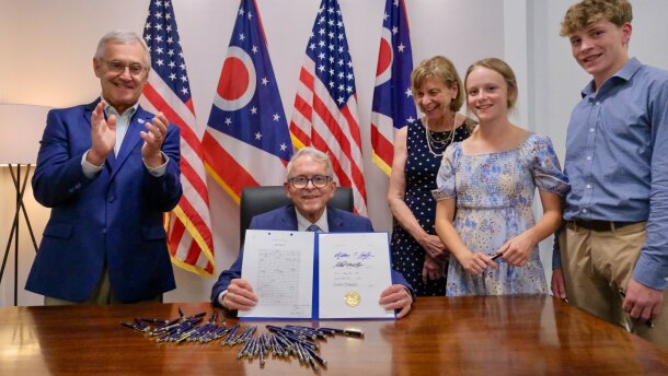 Gov. Mike DeWine shows the budget he signed at the deadline Monday in a photo he shared on X.