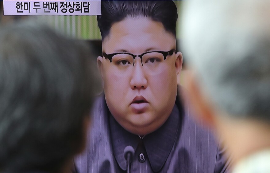 People watch a TV screen showing an image of North Korean leader Kim Jong Un delivering a statement in response to U.S. President Donald Trump's speech to the United Nations, in Pyongyang, North Korea, at Seoul Railway Station in Seoul, South Korea.