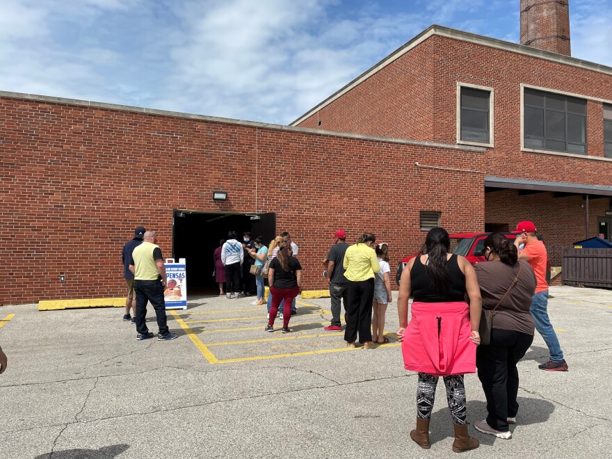 People stood in a line out the door of Franklin Junior High in Des Moines waiting to sign in for their COVID-19 vaccine. The clinic was open for first doses for 12 to 15-year-olds.