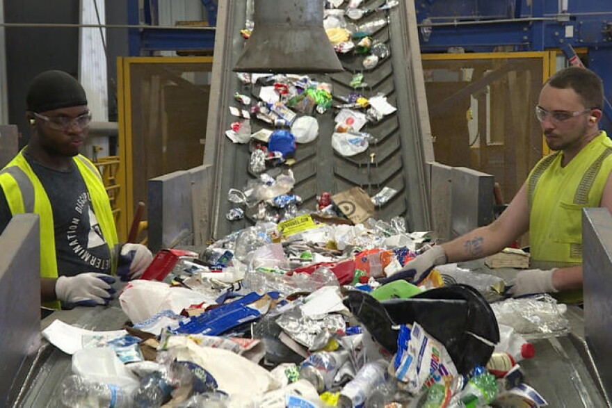 Workers sort recycling at Rumpke's material recovery facility in Cincinnati, Ohio.