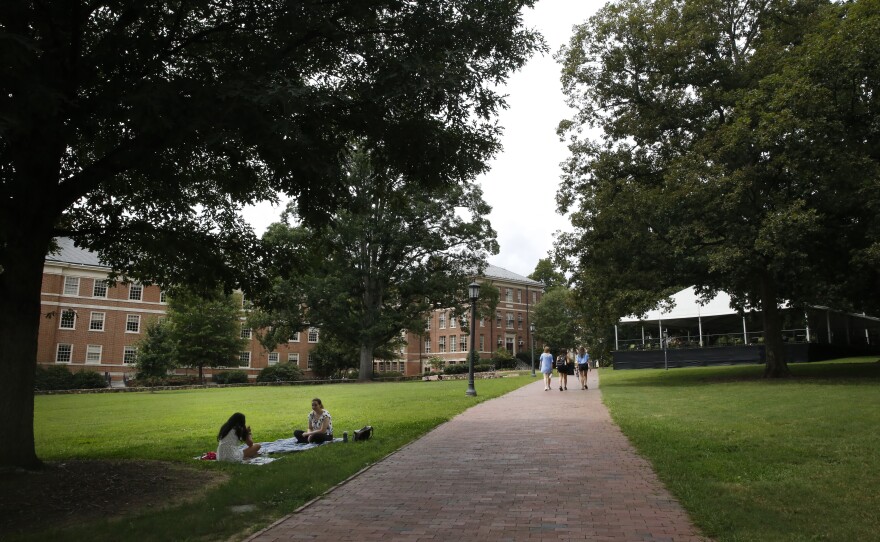Students lounge on campus at the University of North Carolina at Chapel Hill. The university reported its first coronavirus clusters after a week of in-person classes.