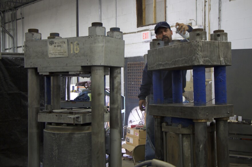 A technician works on one of Quality Record Pressing's newly acquired presses.