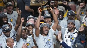 Indiana Pacers center Myles Turner holds the trophy as players celebrate after winning Game 6 of the Eastern Conference finals of the NBA basketball playoffs against the New York Knicks in Indianapolis, Saturday, May 31, 2025.