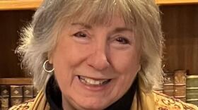 Close up of a woman smiling into the camera. 