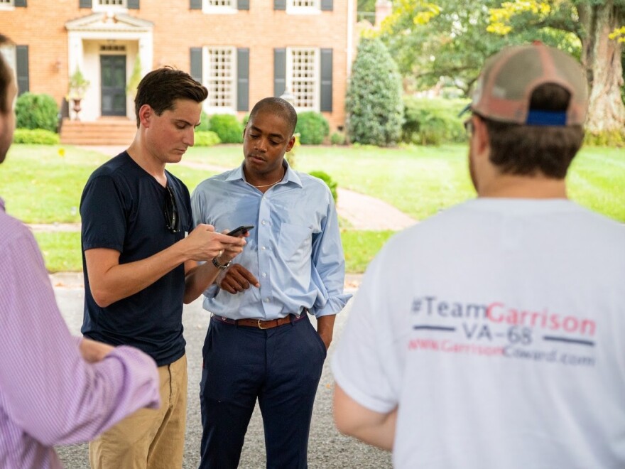 Coward stands alongside campaign volunteers in Richmond, Va.'s Windsor Farms neighborhood.