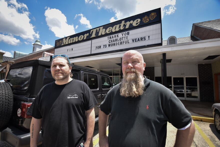 Jay Morang, left, and Brad Ritter stand outside Charlotte's Manor Theatre. The small art house theater announced its permenant closure in late May amid the coronavirus pandemic.