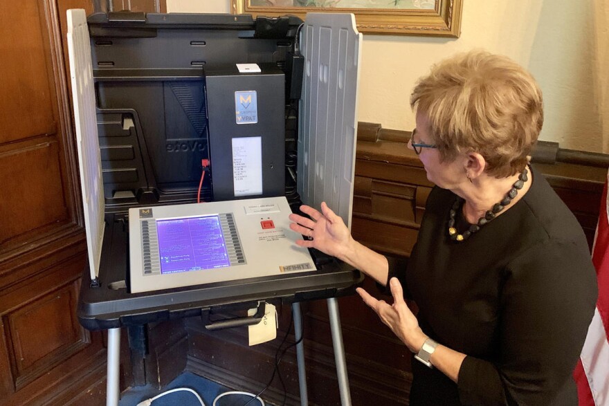 Former Indiana Secretary of State Connie Lawson demonstrates a voter-verifiable paper audit trail on a voting machine.