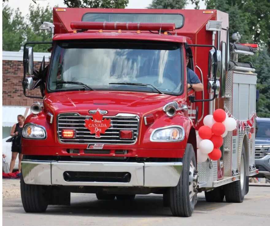 A fire truck drives down Main Street in Emerson, Manitoba as part of the Canada Day Parade on July 1 | MPR News