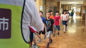 Elementary school students in Iwamizawa, a town in Japan's Hokkaido prefecture, take part in a missile drill.