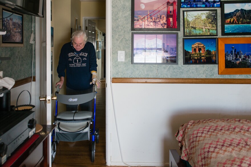 Campbell is able to move around his house with the help of a walker.