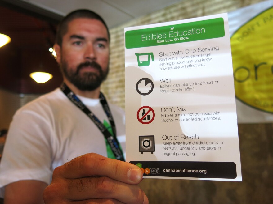 Maka Kalaí, the manager of Organic Alternatives, a recreational and medical marijuana store in Fort Collins, Colo., hands out edibles education cards with each purchase.