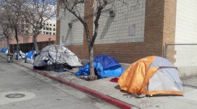 A photo of homeless tents on a sidewalk.