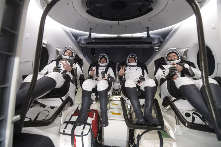 In this photo provided by NASA, from left to right, European Space Agency astronaut Thomas Pesquet, NASA astronauts Megan McArthur and Shane Kimbrough, and Japan Aerospace Exploration Agency astronaut Akihiko Hoshide gesture inside the SpaceX Dragon spacecraft onboard the SpaceX GO Navigator recovery ship shortly after having landed in the Gulf of Mexico off the coast of Pensacola on Nov. 8, 2021. The astronauts returned to Earth on Monday to end a 200-day space station mission that began last spring.