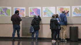 Juneau residents study proposals for new House district boundaries in the Juneau area at an open house event at Centennial Hall in Juneau on Sept. 27, 2021. (Photo by Lyndsey Brollini/KTOO)