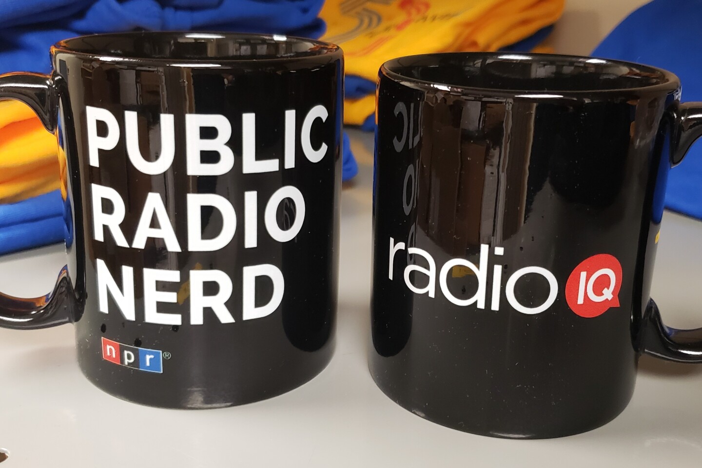 The Public Radio Nerd Mug is an 11-ounce coffee mug with the NPR/Public Radio Nerd logo on one side, and the Radio IQ or WVTF Music logo on the other. Dishwasher and microwave safe. Pledge level: $7.50/month or $90 all at once.