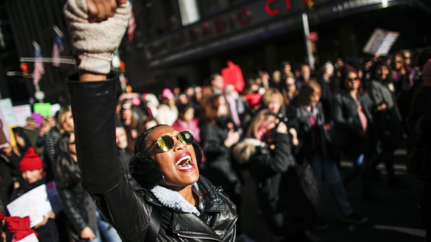 A woman shouts slogans during the Women's March in New York City, January 20, 2018, as protestors took to the streets en masse across the United States. It was a sign of lasting outrage, coming a year after the first women's marches following President Trump's inauguration.