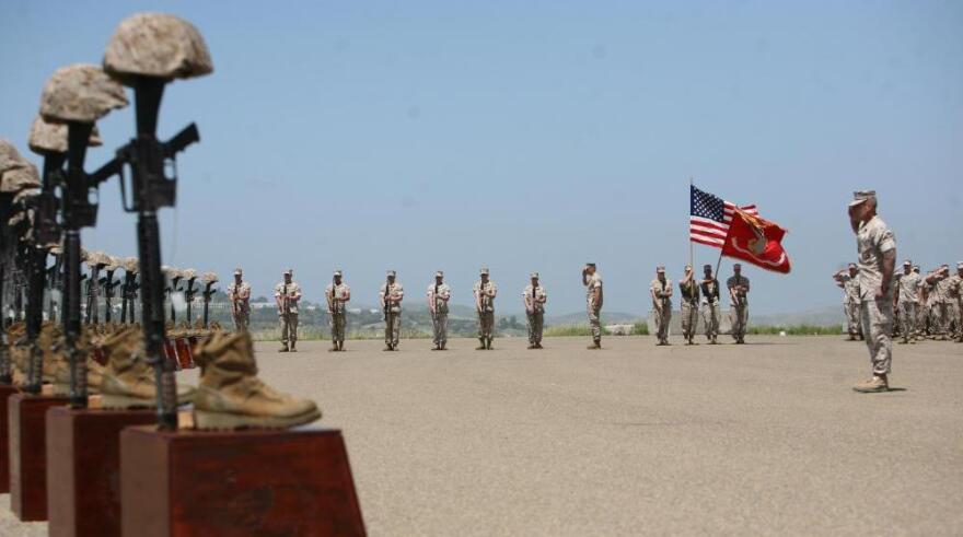 <p>Marines with 3rd Battalion, 5th Regiment salute during the playing of taps at a memorial ceremony on April 29 at Camp Pendleton, Calif. Moments before, the Marines fired a 21-gun salute in honor of the 25 fallen warriors of the battalion.</p>