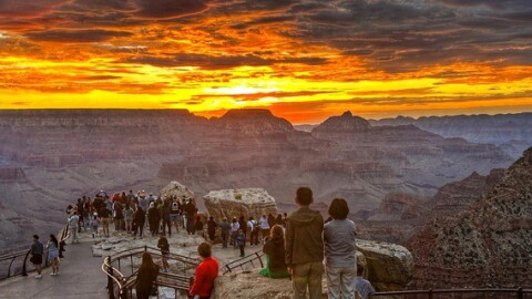 Visitors view sunrise at Mather Point on the South Rim of Grand Canyon National Park.